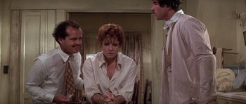 Movie still from “The Fortune” (1975), directed by Mike Nichols – A group of people standing in a living room; Medium shot, Over the shoulder angle