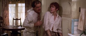 Movie still from “The Fortune” (1975), directed by Mike Nichols – A man and a woman standing next to each other; Medium shot, Low angle