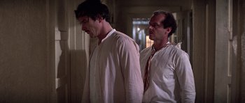 Movie still from “The Fortune” (1975), directed by Mike Nichols – Two men standing next to each other in a room; Medium shot, Low angle