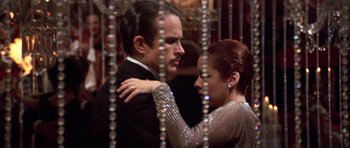 Movie still from “The Fortune” (1975), directed by Mike Nichols – A man and a woman are dancing in a ballroom; Medium shot, Low angle