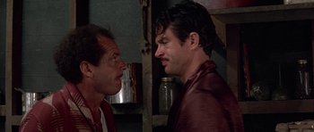 Movie still from “The Fortune” (1975), directed by Mike Nichols – Two men are facing each other in a room; Close Up shot, Over the shoulder angle