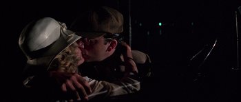 Movie still from “The Fortune” (1975), directed by Mike Nichols – A man and a woman kissing in the dark; Close Up shot, Low angle