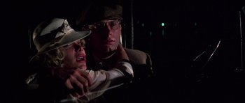 Movie still from “The Fortune” (1975), directed by Mike Nichols – A man and a woman are holding each other in the dark; Close Up shot, Low angle