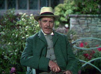 Movie still from “The Four Feathers” (1939), directed by Zoltan Korda – An older man wearing a green jacket and a hat; Medium shot, Over the shoulder angle