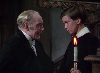 Movie still from “The Four Feathers” (1939), directed by Zoltan Korda – A man and a young boy in a suit and tie; Medium shot, Over the shoulder angle