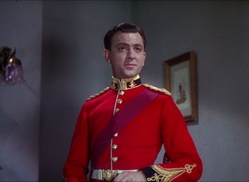 Movie still from “The Four Feathers” (1939), directed by Zoltan Korda – A man in a red and gold military uniform; Medium shot, Low angle