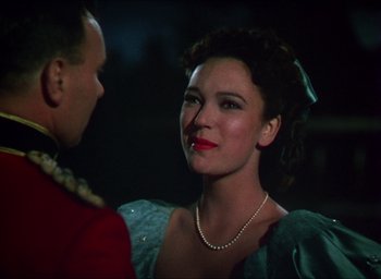 Movie still from “The Four Feathers” (1939), directed by Zoltan Korda – A man and a woman are standing in a dark room; Close Up shot, Over the shoulder angle