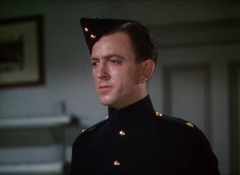 Movie still from “The Four Feathers” (1939), directed by Zoltan Korda – A person wearing a uniform; Close Up shot, Low angle