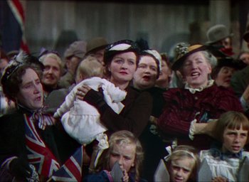 Movie still from “The Four Feathers” (1939), directed by Zoltan Korda – A crowd of people are gathered together in a stadium; Medium shot, Low angle