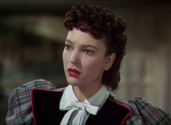 Movie still from “The Four Feathers” (1939), directed by Zoltan Korda – A person wearing a suit and tie; Close Up shot, Over the shoulder angle