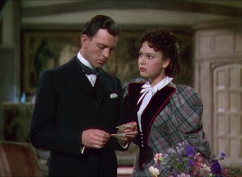 Movie still from “The Four Feathers” (1939), directed by Zoltan Korda – A man and a woman standing next to each other; Medium shot, Over the shoulder angle