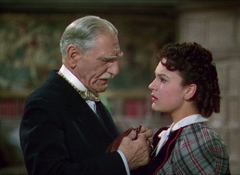 Movie still from “The Four Feathers” (1939), directed by Zoltan Korda – An older man and a young woman holding each other; Close Up shot, Over the shoulder angle