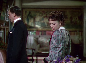 Movie still from “The Four Feathers” (1939), directed by Zoltan Korda – A man and a woman standing next to each other in a room; Medium shot, Over the shoulder angle