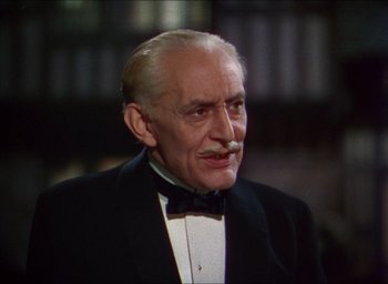Movie still from “The Four Feathers” (1939), directed by Zoltan Korda – An older man in a suit and bow tie; Close Up shot, Over the shoulder angle