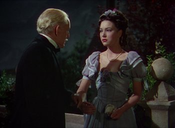 Movie still from “The Four Feathers” (1939), directed by Zoltan Korda – A man and a woman dressed in formal wear; Medium shot, Over the shoulder angle