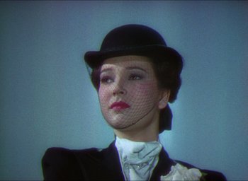Movie still from “The Four Feathers” (1939), directed by Zoltan Korda – A person wearing a suit and hat; Close Up shot, Low angle