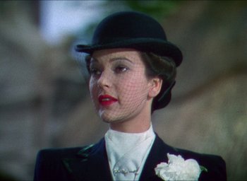 Movie still from “The Four Feathers” (1939), directed by Zoltan Korda – A person wearing a suit and a hat; Close Up shot, Low angle