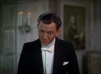 Movie still from “The Four Feathers” (1939), directed by Zoltan Korda – A man wearing a tuxedo and a bow tie; Close Up shot, High angle