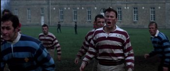 Movie still from “The Four Feathers” (2002), directed by Shekhar Kapur – A group of men standing on top of a grass covered field; Medium shot, Low angle