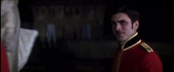 Movie still from “The Four Feathers” (2002), directed by Shekhar Kapur – A person wearing a suit and tie; Close Up shot, Over the shoulder angle