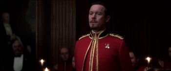 Movie still from “The Four Feathers” (2002), directed by Shekhar Kapur – A man in a red and gold military uniform; Close Up shot, Low angle