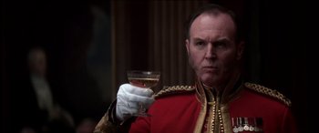 Movie still from “The Four Feathers” (2002), directed by Shekhar Kapur – A man in a uniform holding a glass of wine; Close Up shot, Low angle