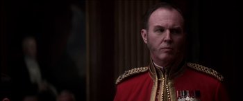 Movie still from “The Four Feathers” (2002), directed by Shekhar Kapur – A person wearing a red and gold uniform; Close Up shot, Over the shoulder angle