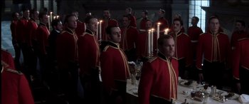 Movie still from “The Four Feathers” (2002), directed by Shekhar Kapur – A group of men standing next to each other in front of candles; Medium shot, High angle