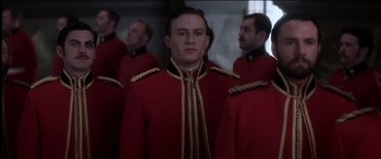 Movie still from “The Four Feathers” (2002), directed by Shekhar Kapur – A group of men in red and gold uniforms; Medium shot, Low angle