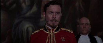 Movie still from “The Four Feathers” (2002), directed by Shekhar Kapur – A man in a red and gold military uniform; Close Up shot, Low angle