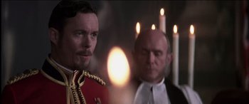 Movie still from “The Four Feathers” (2002), directed by Shekhar Kapur – A man in a uniform standing next to another man in a suit; Close Up shot, Over the shoulder angle