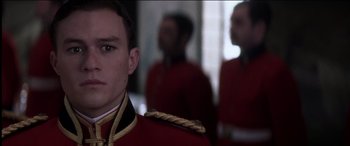 Movie still from “The Four Feathers” (2002), directed by Shekhar Kapur – A person wearing a red uniform; Close Up shot, Low angle