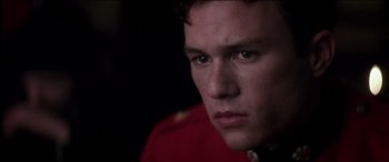 Movie still from “The Four Feathers” (2002), directed by Shekhar Kapur – A person wearing a red jacket; Close Up shot, Over the shoulder angle