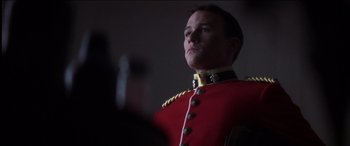 Movie still from “The Four Feathers” (2002), directed by Shekhar Kapur – A man in a red and black uniform looking up; Close Up shot, Low angle