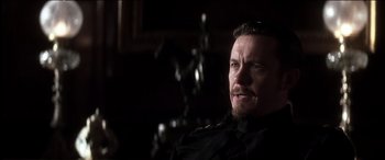 Movie still from “The Four Feathers” (2002), directed by Shekhar Kapur – A person sitting in a chair; Close Up shot, Over the shoulder angle