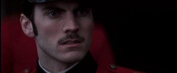 Movie still from “The Four Feathers” (2002), directed by Shekhar Kapur – A person wearing a red jacket; Close Up shot, Over the shoulder angle