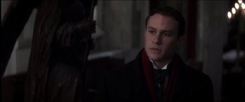 Movie still from “The Four Feathers” (2002), directed by Shekhar Kapur – A man in a suit and a red scarf; Close Up shot, Over the shoulder angle