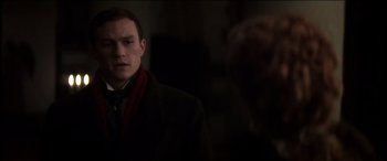 Movie still from “The Four Feathers” (2002), directed by Shekhar Kapur – A man wearing a suit and a red scarf; Close Up shot, Over the shoulder angle