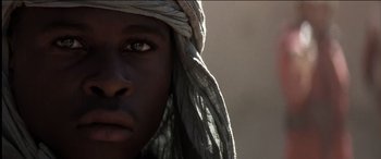Movie still from “The Four Feathers” (2002), directed by Shekhar Kapur – A person wearing a head covering; Extreme Close Up shot, Low angle