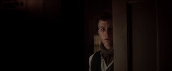 Movie still from “The Four Feathers” (2002), directed by Shekhar Kapur – A man standing in front of a door looking at the camera; Close Up shot, Low angle