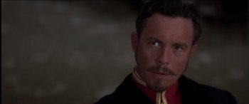 Movie still from “The Four Feathers” (2002), directed by Shekhar Kapur – A person wearing a black and red jacket; Close Up shot, Over the shoulder angle