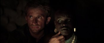 Movie still from “The Four Feathers” (2002), directed by Shekhar Kapur – A man standing next to a woman in a dark room; Close Up shot, Over the shoulder angle