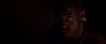 Movie still from “The Four Feathers” (2002), directed by Shekhar Kapur – A person's face in the dark; Close Up shot, Low angle