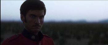 Movie still from “The Four Feathers” (2002), directed by Shekhar Kapur – A person wearing a red uniform; Close Up shot, Over the shoulder angle