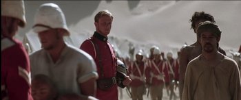 Movie still from “The Four Feathers” (2002), directed by Shekhar Kapur – A group of men in red and white uniforms; Medium shot, Low angle