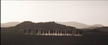 Movie still from “The Four Feathers” (2002), directed by Shekhar Kapur – A group of people riding on the backs of horses; Extreme Wide shot, Low angle