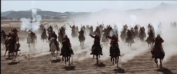 Movie still from “The Four Feathers” (2002), directed by Shekhar Kapur – A group of people riding horses in the desert; Extreme Wide shot, High angle