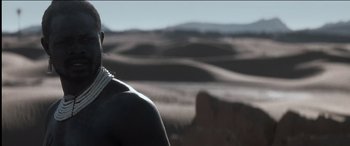 Movie still from “The Four Feathers” (2002), directed by Shekhar Kapur – A man standing on top of a hill with mountains in the background; Close Up shot, Over the shoulder angle