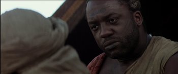 Movie still from “The Four Feathers” (2002), directed by Shekhar Kapur – A person with a beard looking at the camera; Close Up shot, Low angle