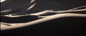 Movie still from “The Four Feathers” (2002), directed by Shekhar Kapur – A person riding a horse on top of a snow covered slope; Extreme Wide shot, High angle